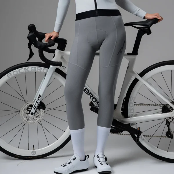 Pantalón de ciclismo Rockbros LKK2000 gris puesto, junto a una bici de ruta